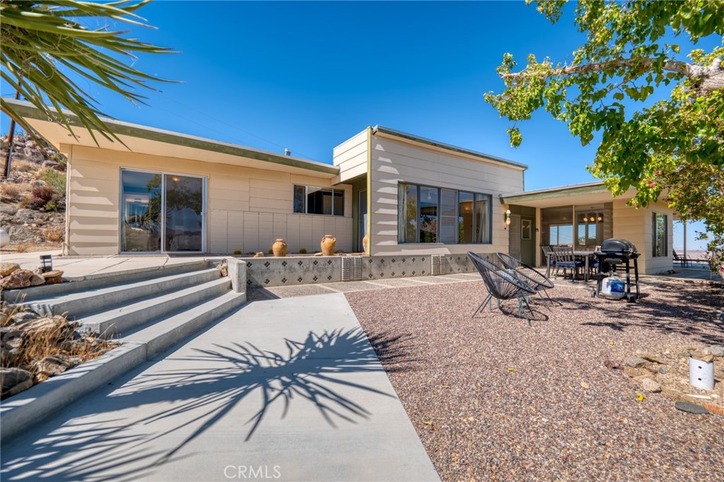 8775 Vía Rocosa Joshua Tree, CA 92252 - Photo 1 of 1 a view of a house with backyard and sitting area