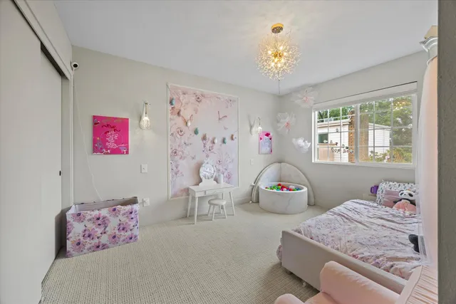 a view of a dining room with furniture and chandelier