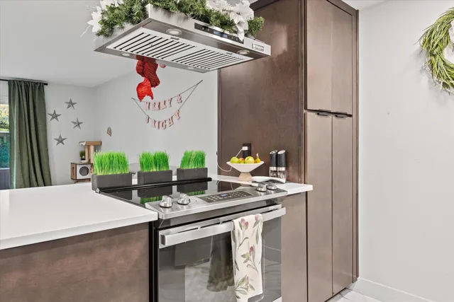 a kitchen with stainless steel appliances granite countertop a sink and a white cabinets
