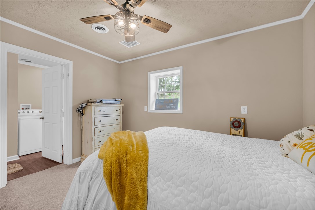 3030 Smith McGee Road Iva, SC 29655 - Photo 39 of 46 A cozy retreat, this bedroom offers carpeted flooring and a convenient in-room laundry area.