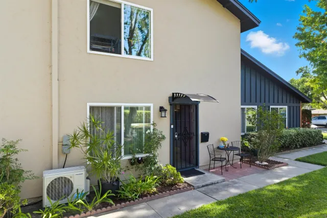 a view of a house with backyard sitting area and garden