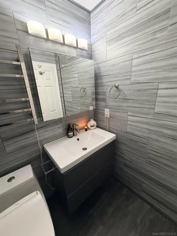 a bathroom with a sink toilet and mirror