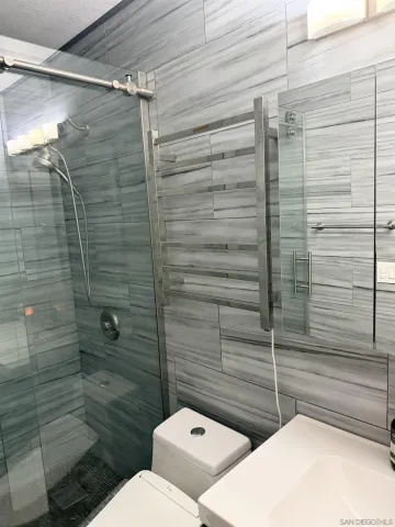 a bathroom with a toilet and shower