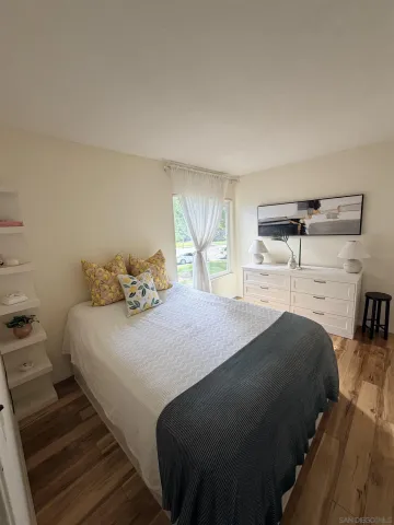 a bedroom with a bed and window