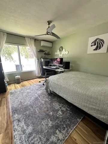 a bedroom with a bed and a large window