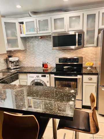 a kitchen with a stove and a microwave