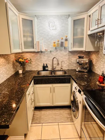 a kitchen with a sink and cabinets