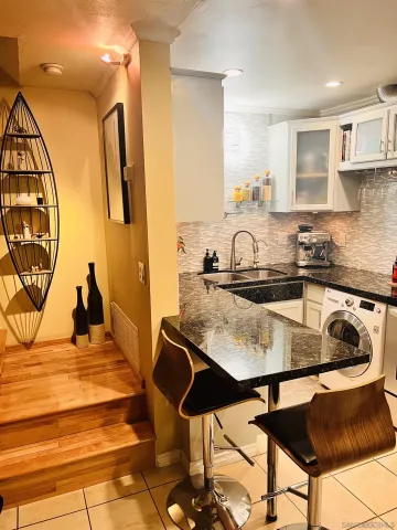 a kitchen with a table chairs and a refrigerator