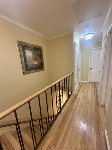 a view of hallway with wooden floor