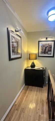 a room with a bed and painting on the wall