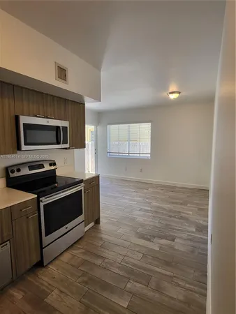 a kitchen with granite countertop a stove top oven and sink