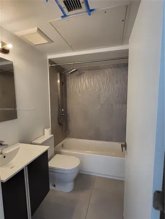 a bathroom with a bathtub and sink