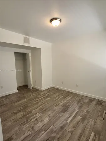 a view of an empty room and wooden floor