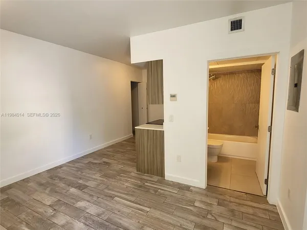 a view of a hallway with wooden floor