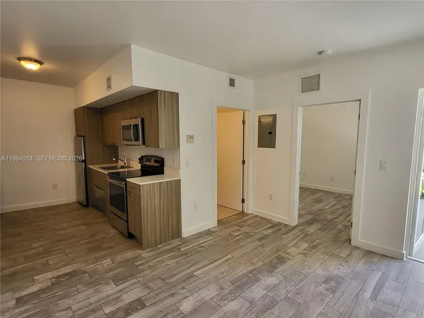 a kitchen with a refrigerator and a stove