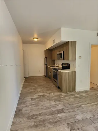 a kitchen with stainless steel appliances a refrigerator and a stove top oven