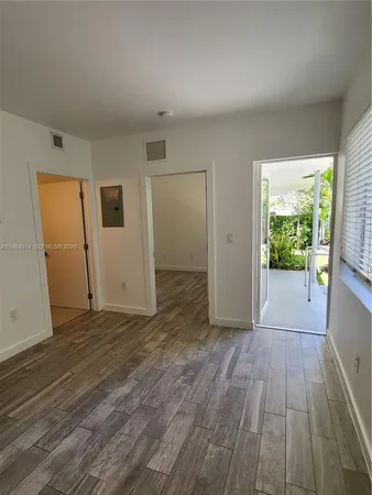 a view of a livingroom with wooden floor and window