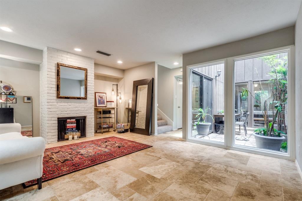 a spacious bedroom with a large bed and a fireplace with outer view