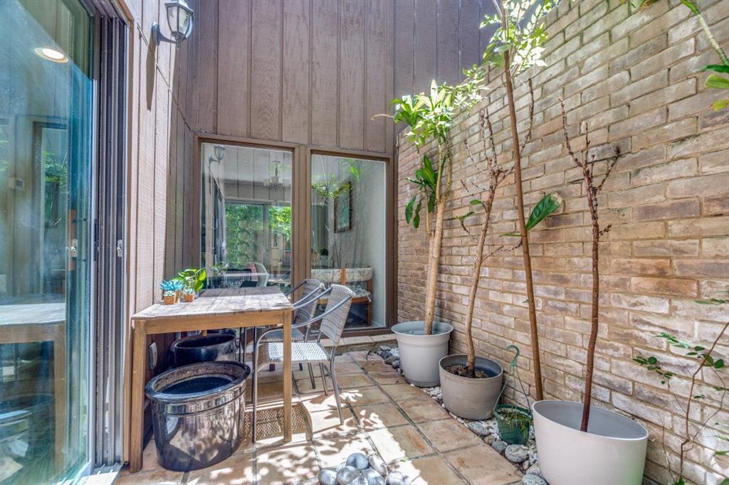3736 Vitruvian Way, Unit D5 Addison, TX 75001 - Photo 17 of 27 a view of a porch with chairs and potted plants