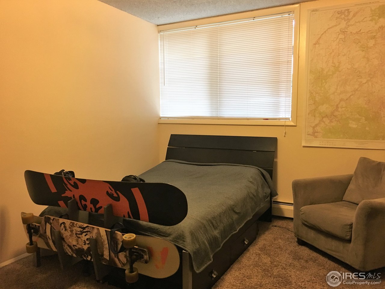 2707 Valmont Road, Unit 114 Boulder, CO 80304 - Photo 3 of 21 a bed sitting in a bedroom next to a window