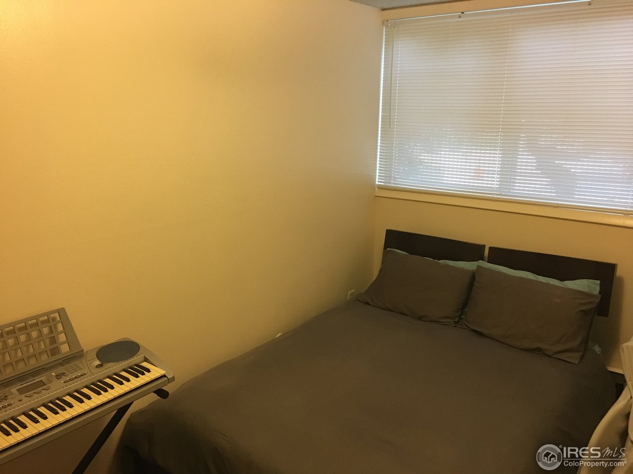2707 Valmont Road, Unit 114 Boulder, CO 80304 - Photo 7 of 21 a bed sitting in a room next to a window