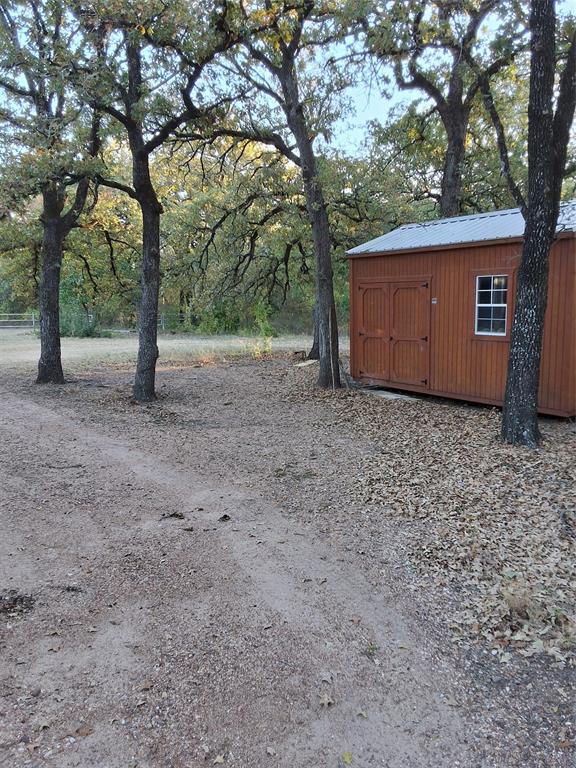 5765 Tokio Road West, TX 76691 - Photo 2 of 10 View of yard with a storage unit