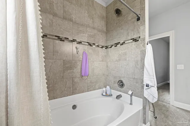 a bathroom with a tub and a shower