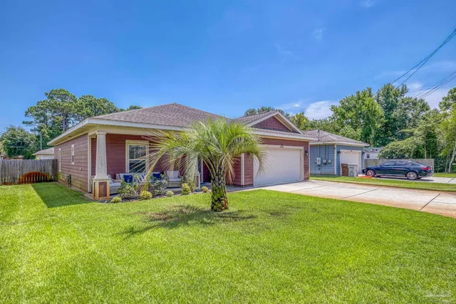 a house view with a sitting space and garden