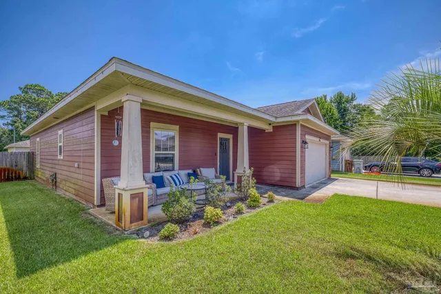 a front view of a house with a yard and porch