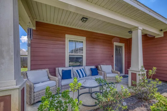 a front view of a house with outdoor seating