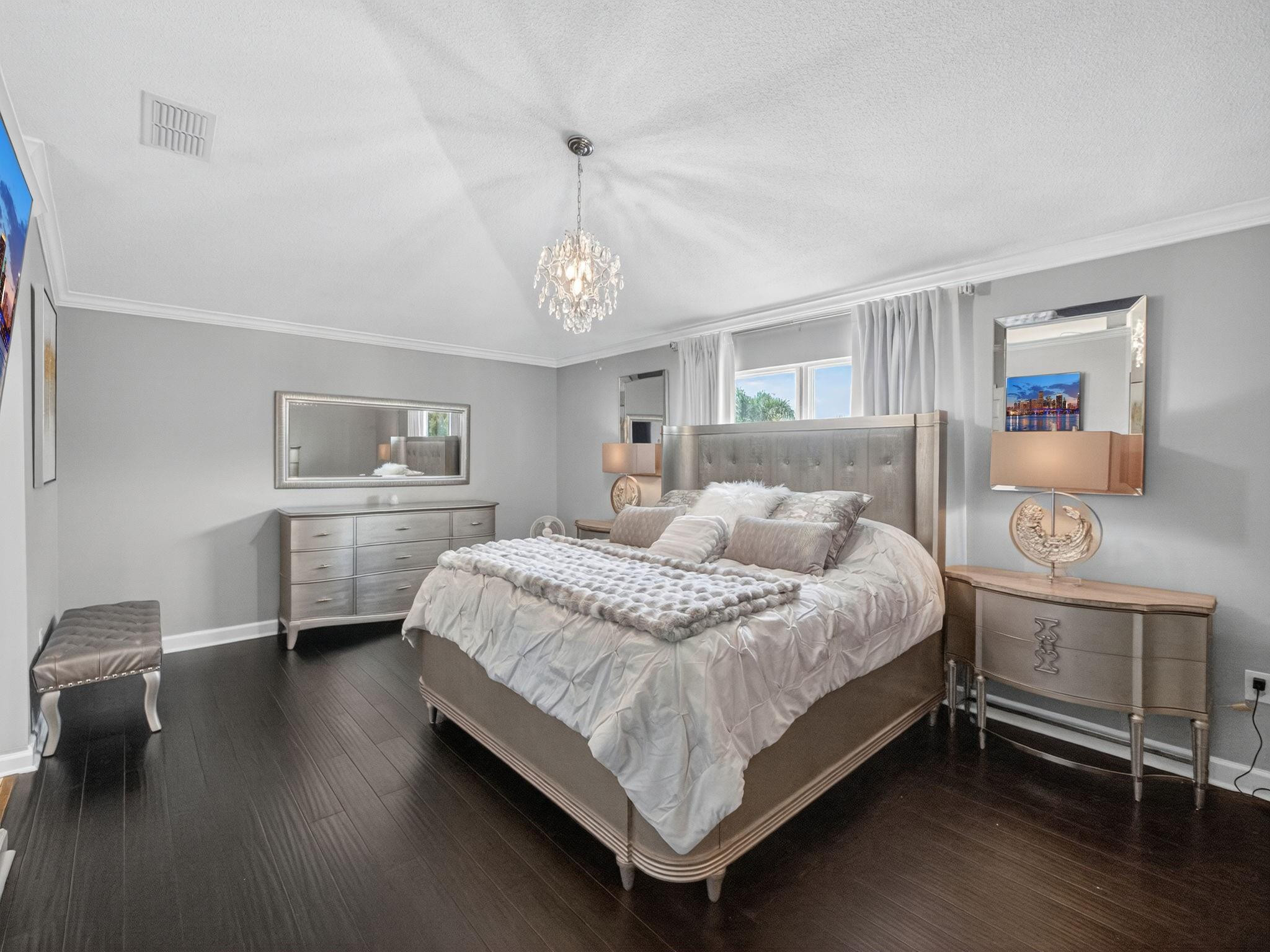 4125 Southwest Webb Street Port St. Lucie, FL 34953 - Photo 12 of 29 a bedroom with a bed wooden floor and window