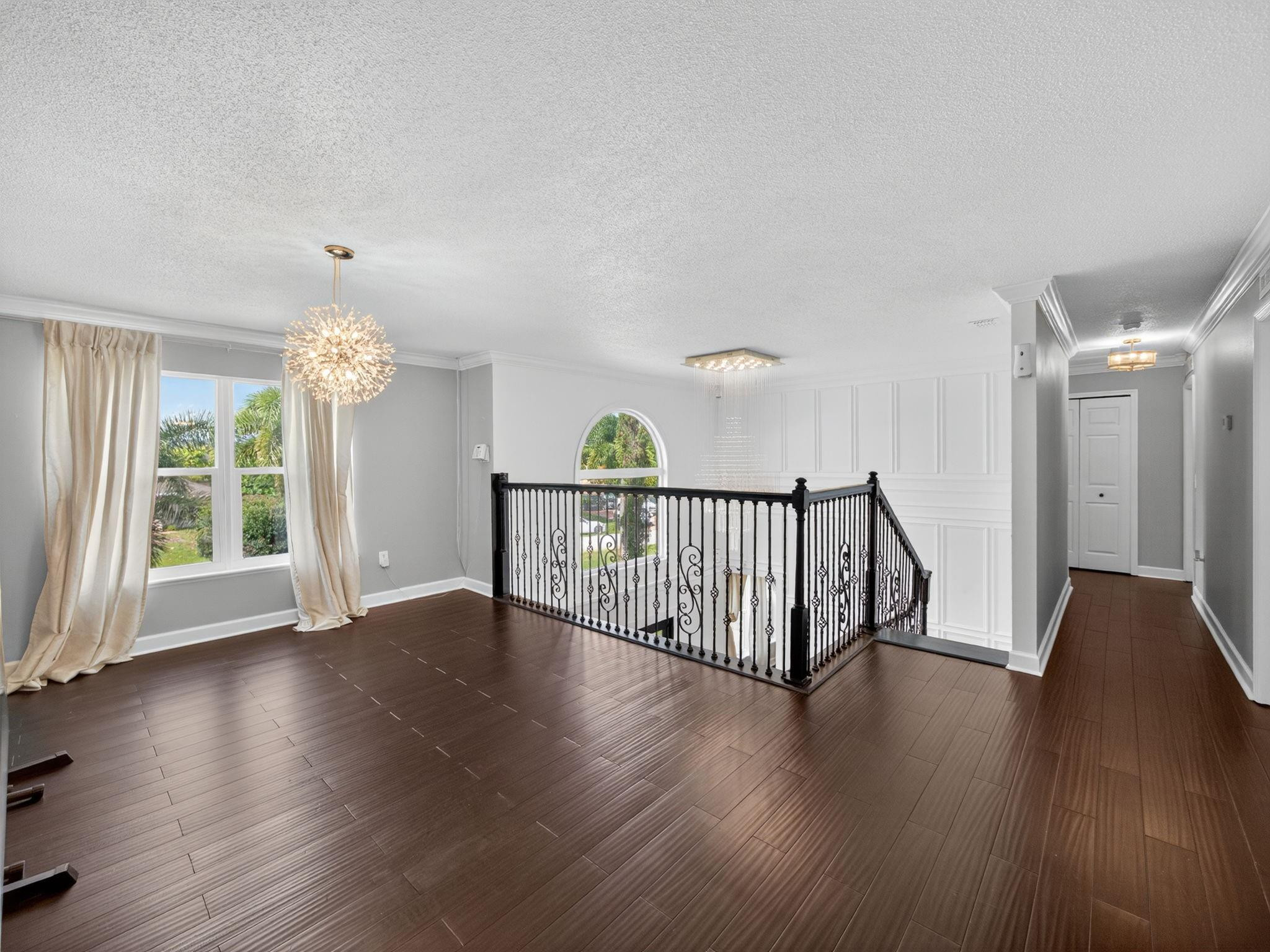4125 Southwest Webb Street Port St. Lucie, FL 34953 - Photo 17 of 29 a view of a hallway with wooden floor and a window