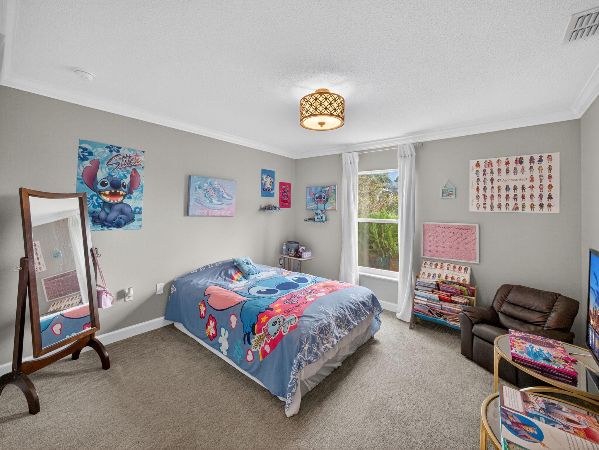 4125 Southwest Webb Street Port St. Lucie, FL 34953 - Photo 20 of 29 a bedroom with a bed and a chandelier