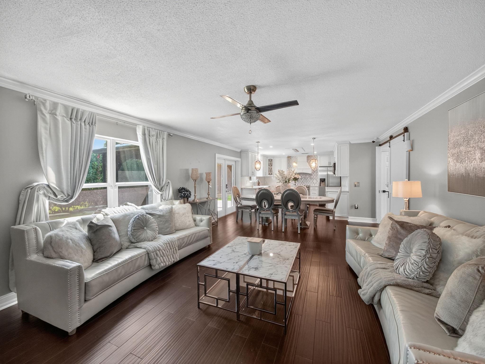4125 Southwest Webb Street Port St. Lucie, FL 34953 - Photo 2 of 29 a living room with furniture kitchen view and a large window