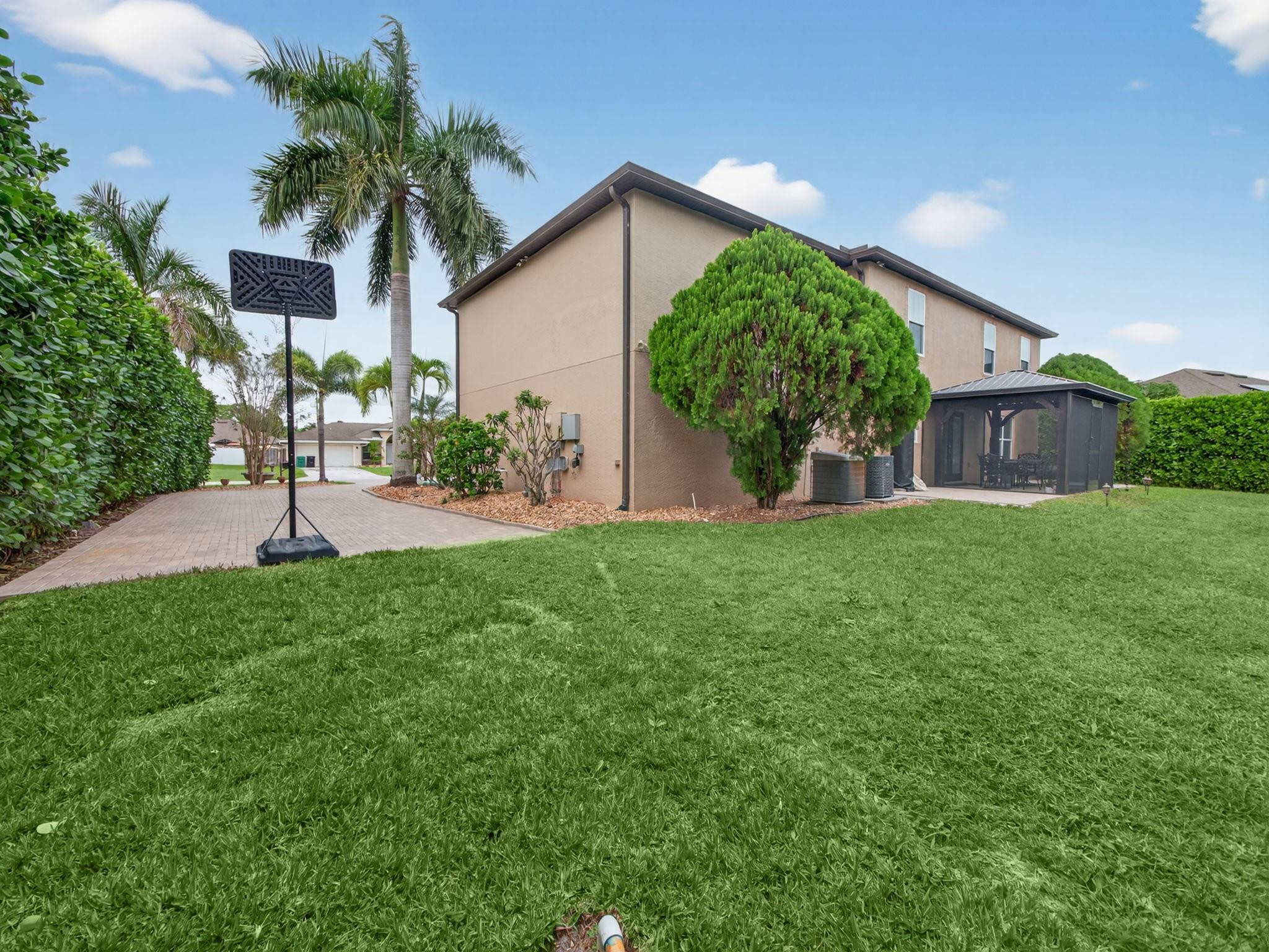 4125 Southwest Webb Street Port St. Lucie, FL 34953 - Photo 26 of 29 a view of a chair and table in backyard of the house