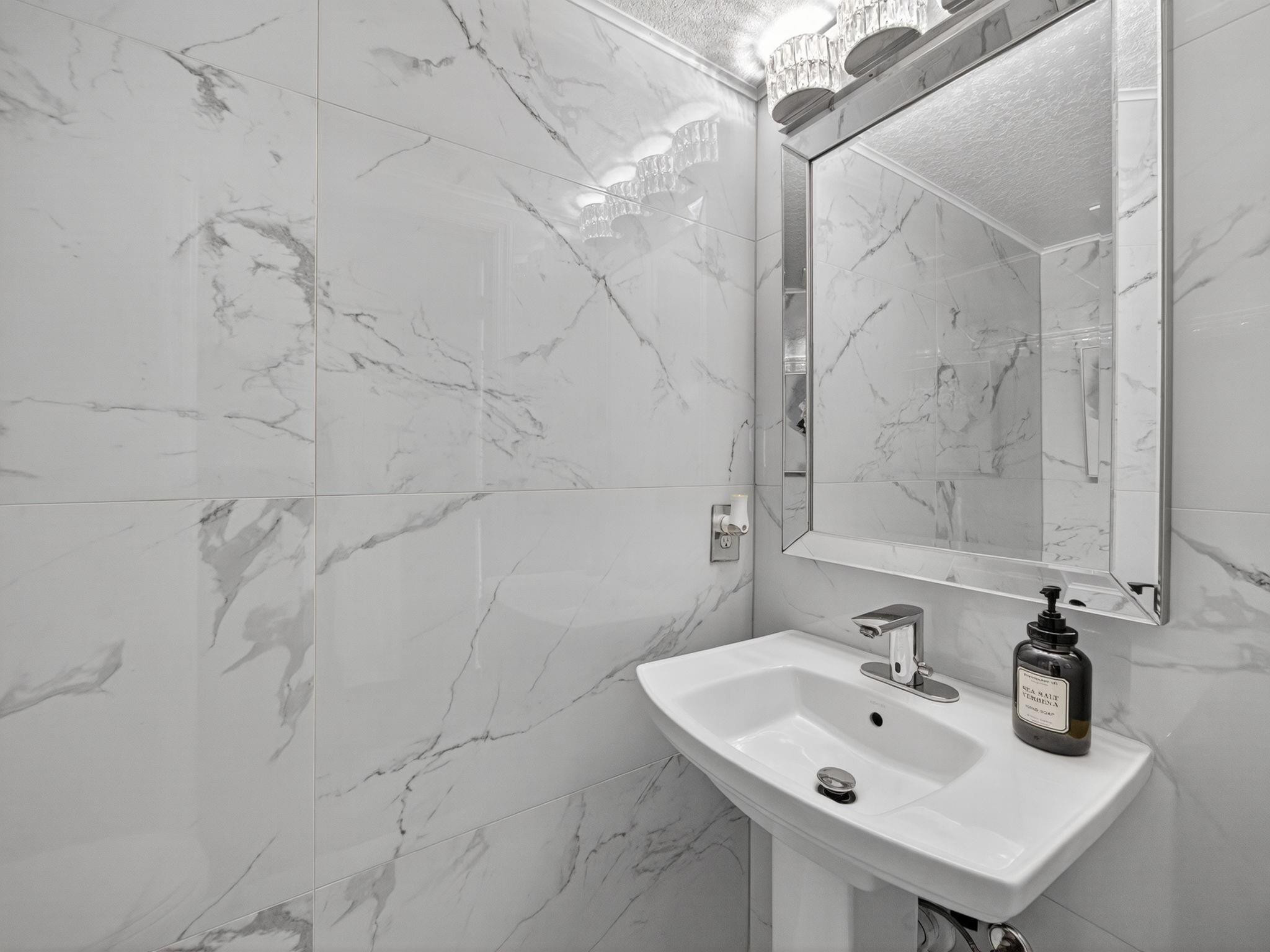 4125 Southwest Webb Street Port St. Lucie, FL 34953 - Photo 5 of 29 a bathroom with a sink shower and a mirror