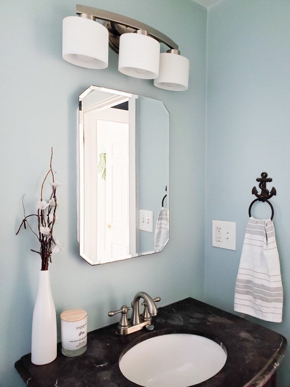 16 Griffin Road Peabody, MA 01960 - Photo 12 of 26 a bathroom with a sink and a mirror