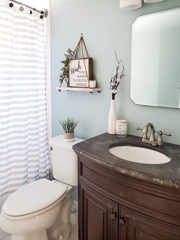 16 Griffin Road Peabody, MA 01960 - Photo 13 of 26 a bathroom with a toilet a sink and mirror