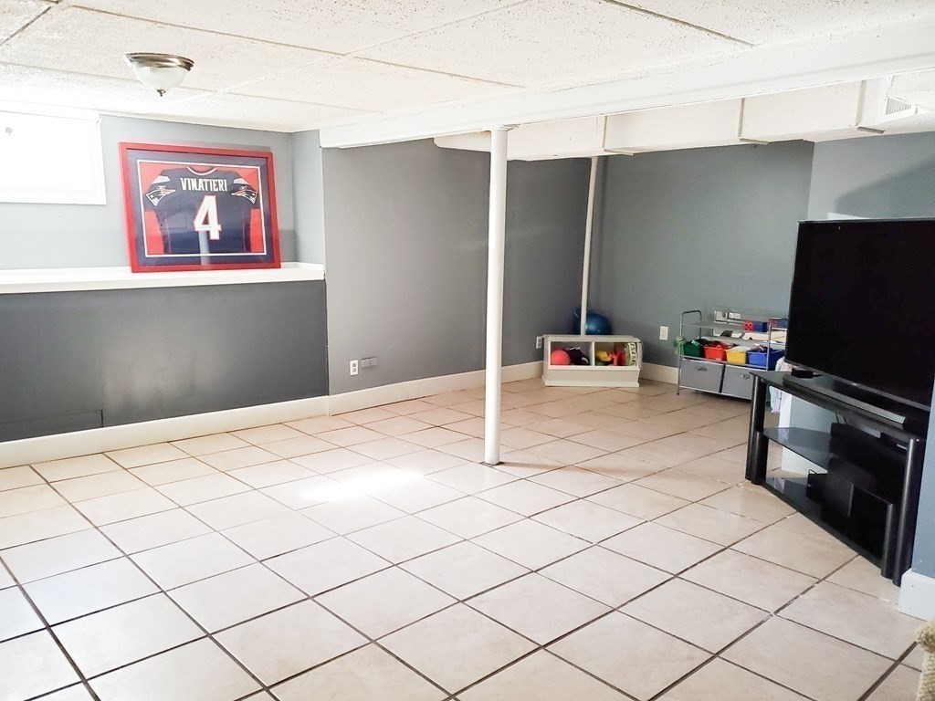 16 Griffin Road Peabody, MA 01960 - Photo 17 of 26 a bedroom with a bed and a flat screen tv