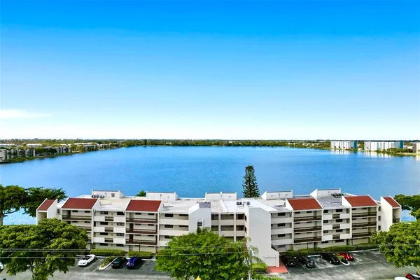 a kitchen with granite countertop a sink stove and refrigerator