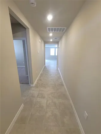 a view of kitchen with kitchen island granite countertop a refrigerator and a stove top oven
