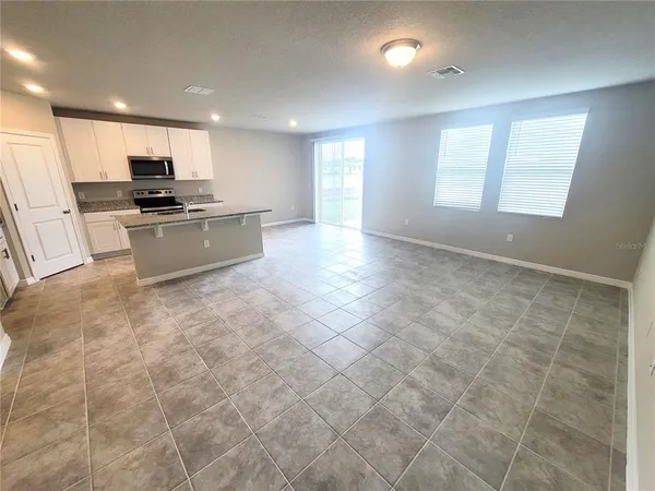 a kitchen with stainless steel appliances granite countertop a sink stove and microwave