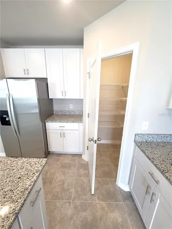 a kitchen with white cabinets