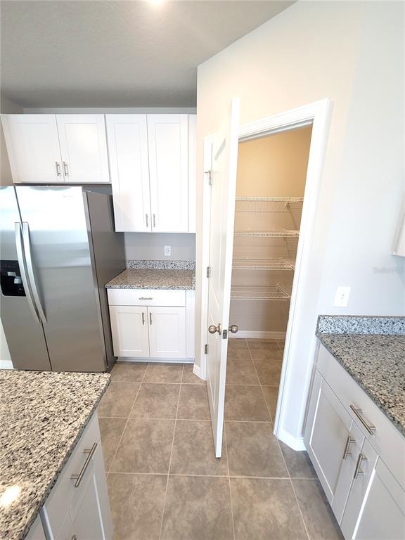 1618 Bark Rdg Drive Auburndale, FL 33823 - Photo 19 of 40 a kitchen with a sink stove and refrigerator