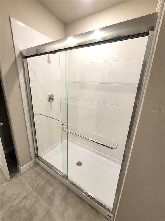 1618 Bark Rdg Drive Auburndale, FL 33823 - Photo 33 of 40 a bathroom with a glass shower door