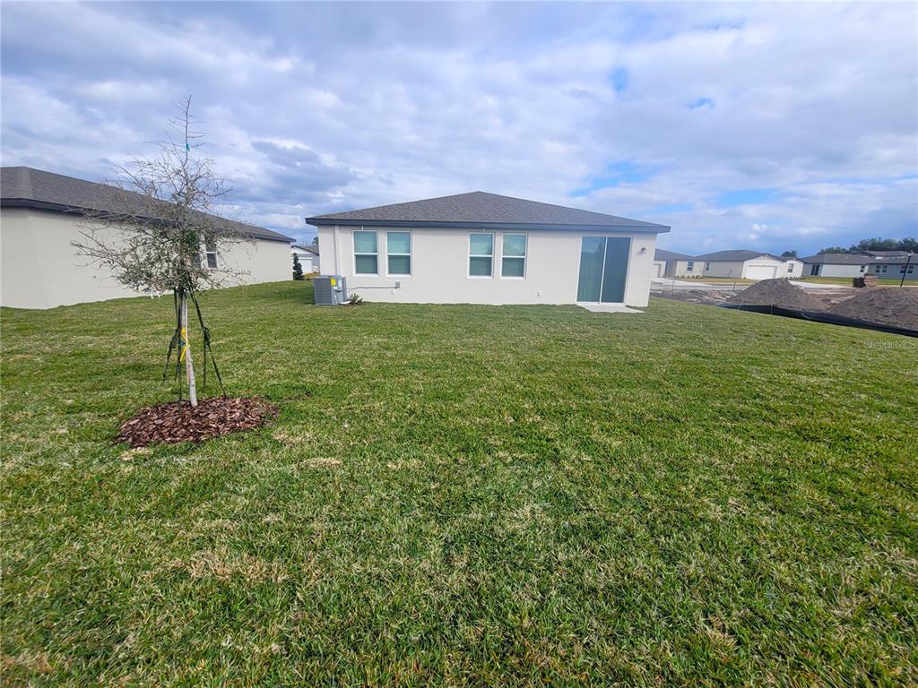 1618 Bark Rdg Drive Auburndale, FL 33823 - Photo 36 of 40 a front view of a house with a garden