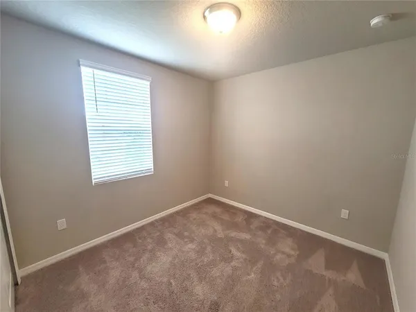 an empty room with closet area