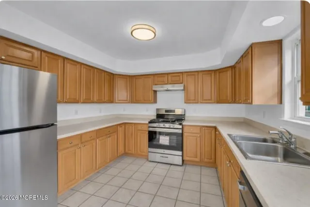 a view of a kitchen with a refrigerator cabinets and a wooden floor