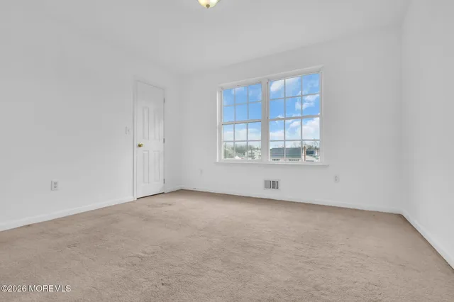 a view of an empty room and closet