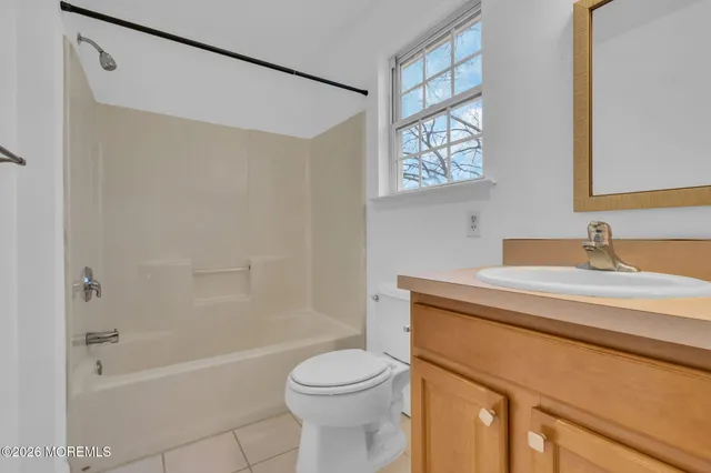 a view of a fountain in front of a house with a big yard